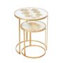 EVERGREEN ENTERPRISES INC Nested Metal Tables, Set of 2 Instantly elevate your living room or bedroom with this set of two elegant gold metal tables. The stunning metallic details bring effortless glamour to your space. The smaller table perfectly nestles underneath the larger sibling for functionalilty and instant style. Each table features a distressed gold leaf on a plate of round glass. Intended for indoor use only. 