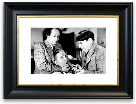 East Urban Home 'The Three Stooges tooth Pull' Framed Photographic Print East Urban Home Size: 50 cm H x 70 cm W, Frame Options: Matte Black  - Size: 50 cm H x 70 cm W