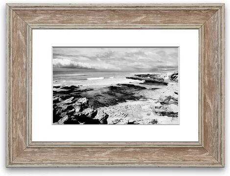 East Urban Home 'Rocks of the Ocean Black and White Cornwall' Framed Photographic Print East Urban Home Size: 93 cm H x 126 cm W, Frame Options: Walnut  - Size: 93 cm H x 126 cm W