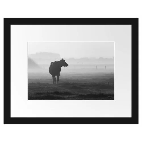 East Urban Home Cow Eating on a Pasture Framed Photographic Print Poster in Black and White East Urban Home  - Size: 40cm H x 55cm W