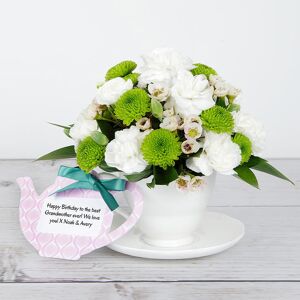www.flowercard.co.uk Teacup and Saucer with White Spray Roses, Lime Santini, White Waxflower, Rustic Ruscus