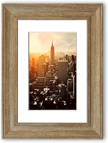 East Urban Home 'Empire State Building Sun Glow' Framed Graphic Art Print East Urban Home Size: 70 cm H x 50 cm W, Frame Options: Teak  - Size: 70 cm H x 93 cm W