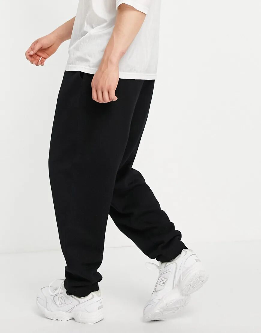 ASOS DESIGN organic oversized joggers in black with toggle hem  Black