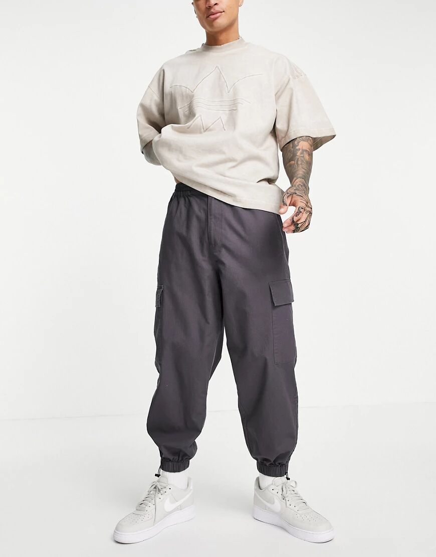 ASOS DESIGN oversized tapered cargo trousers with toggle hem in grey  Grey