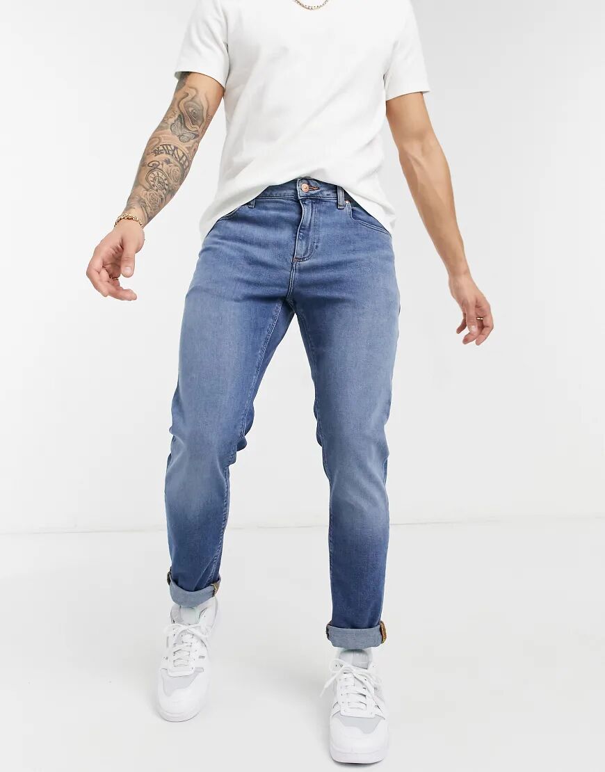 ASOS DESIGN stretch slim jeans in 'less thirsty' mid blue wash  Blue