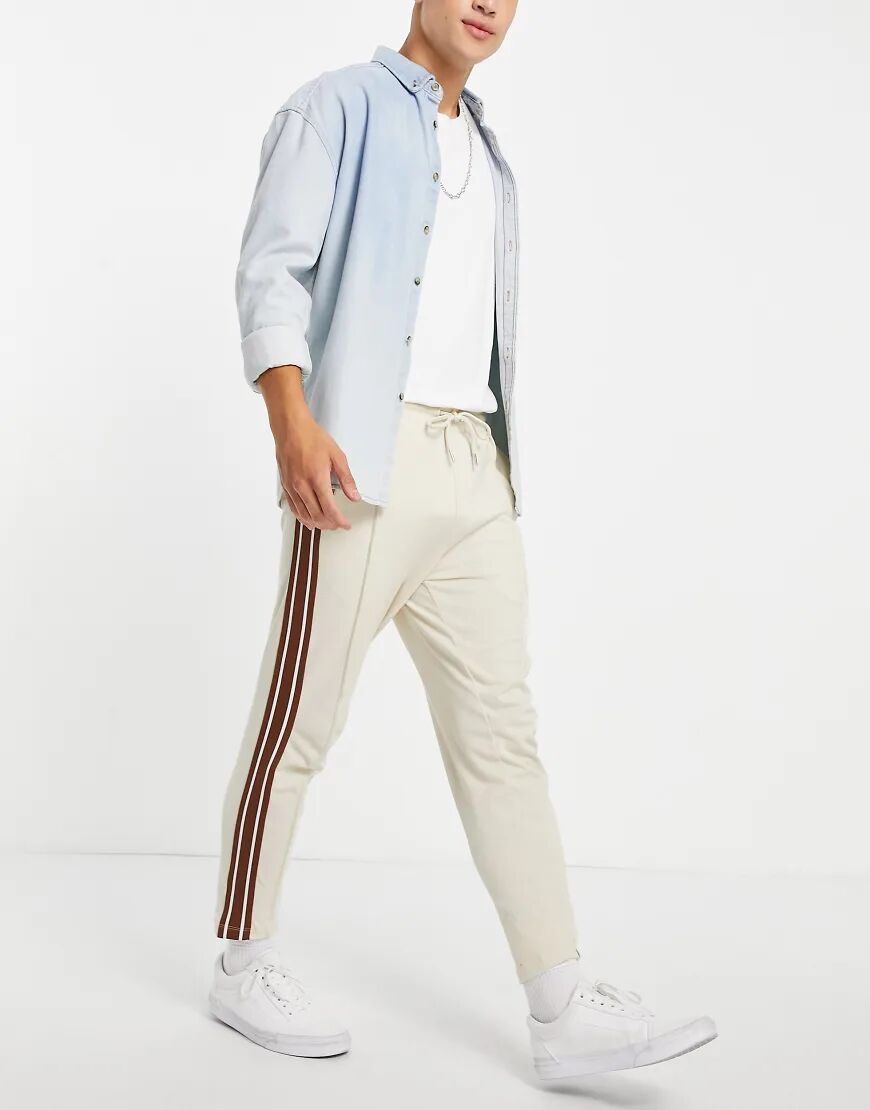 ASOS DESIGN tapered fixed hem joggers with pin tucks & side tape in beige-Neutral  Neutral