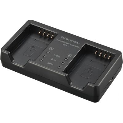 OM System BCX-1 Chargeur pour 2x BLX-1 - Publicité OM System BCX-1 Chargeur pour 2x BLX-1 - Publicité