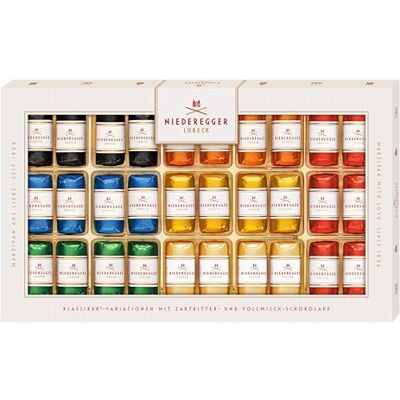 Niederegger pains au massepain chocolaté, boîte de 375 g Plusieurs variétés assorties réunies dans un conditionnement, avec différentes déclinaisons proposées au sein de la sélection - Publicité Niederegger pains au massepain chocolaté, boîte de 375 g Plusieurs variétés assorties réunies dans un conditionnement, avec différentes déclinaisons proposées au sein de la sélection - Publicité