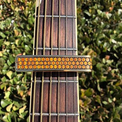 Thalia Premium Series capodaster met zwarte chromen afwerking en inleg van gekrulde Hawaiiaanse koa in honingraatpatroon Thalia Premium Series capodaster met zwarte chromen afwerking en inleg van gekrulde Hawaiiaanse koa in honingraatpatroon
