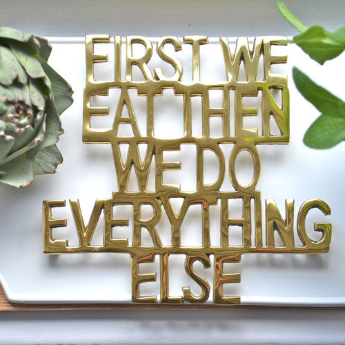 Happy Larry First We Eat Trivet Happy Larry Colour: Brass  - Size: 125cm H x 181cm W Happy Larry First We Eat Trivet Happy Larry Colour: Brass  - Size: 125cm H x 181cm W