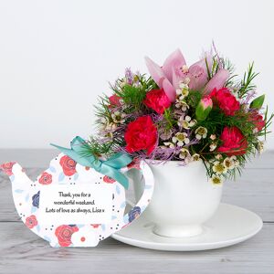 www.flowercard.co.uk Cymbidium Orchids and Pink Spray Carnations with White Wax Flowers and Green Tree Fern in Bone China Teacup