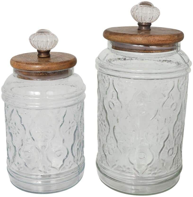 Litton Lane Clear Glass Floral Decorative Jars with Brown Wooden Lids and Antique Style Knobs (Set of 2)