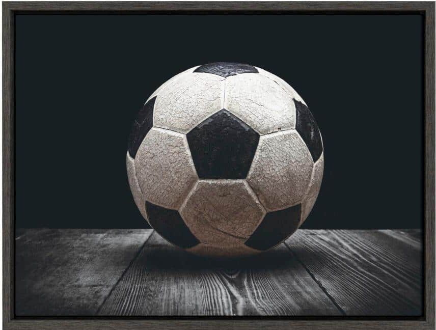 DesignOvation Sylvie "Vintage Soccer Ball on Black" by Saint and Sailor Studios 24 in. x 18 in. Framed Canvas Wall Art