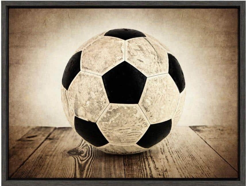 DesignOvation Sylvie "Vintage Soccer on Wood" by Saint and Sailor Studios Sports Framed Canvas Wall Art 24 in. x 18 in.