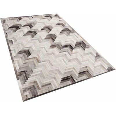 Alfombra de piel Beliani - 140x200 cm - Patrón geométrico moderno Alfombra de piel Beliani - 140x200 cm - Patrón geométrico moderno